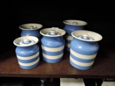 Five TG Green Cornish ware storage canisters or jars, three medium, one large and one smaller.