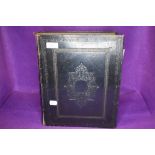 An antique family bible having embossed leather cover.