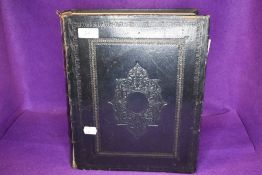 An antique family bible having embossed leather cover.