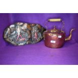 A copper stove kettle and a similar tribal style copper plaque