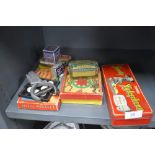 A mixed lot of vintage games, a ticket punch and advertising tins including a Sooty Xylophone in