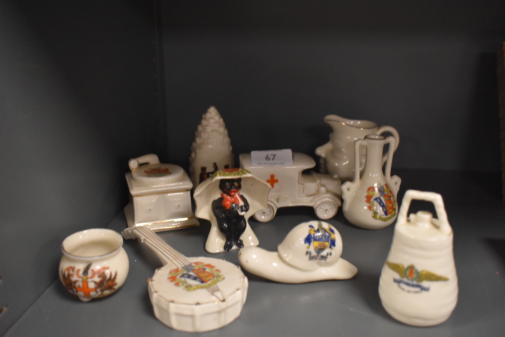 A collection of crested ware including ambulance marked for Windermere, and cat with umbrella for