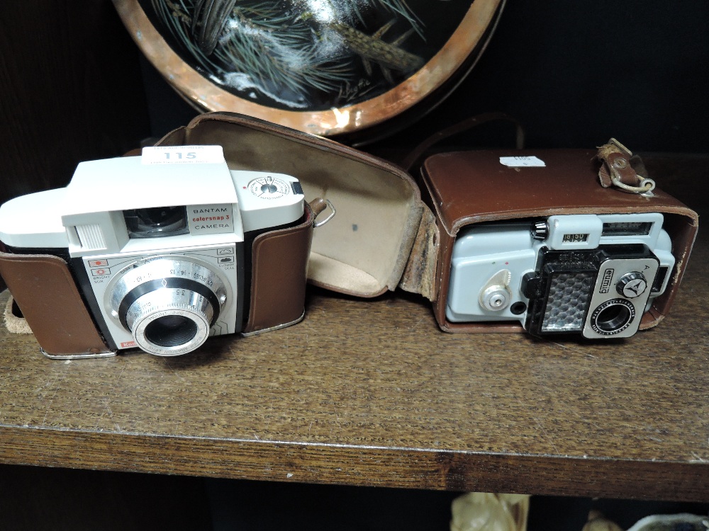 Two vintage cameras including Kodak and Eumig.