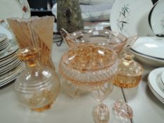 A selection of art deco pink pressed glass items including vase and fruit bowl