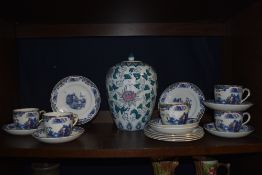 A selection of oriental style cups and saucers and a large jar.