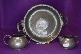 A Tudric pewter tazza or footed bowl having Art Nouveau styling and a Talbot pewter sugar basin