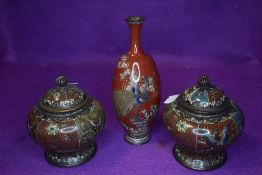 Two Cloisonné lidded pots with butterflies,birds and vines and a intricately detailed vase having