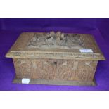 A vintage carved oak box having extensive detail throughout.