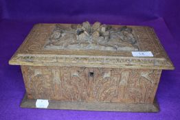 A vintage carved oak box having extensive detail throughout.