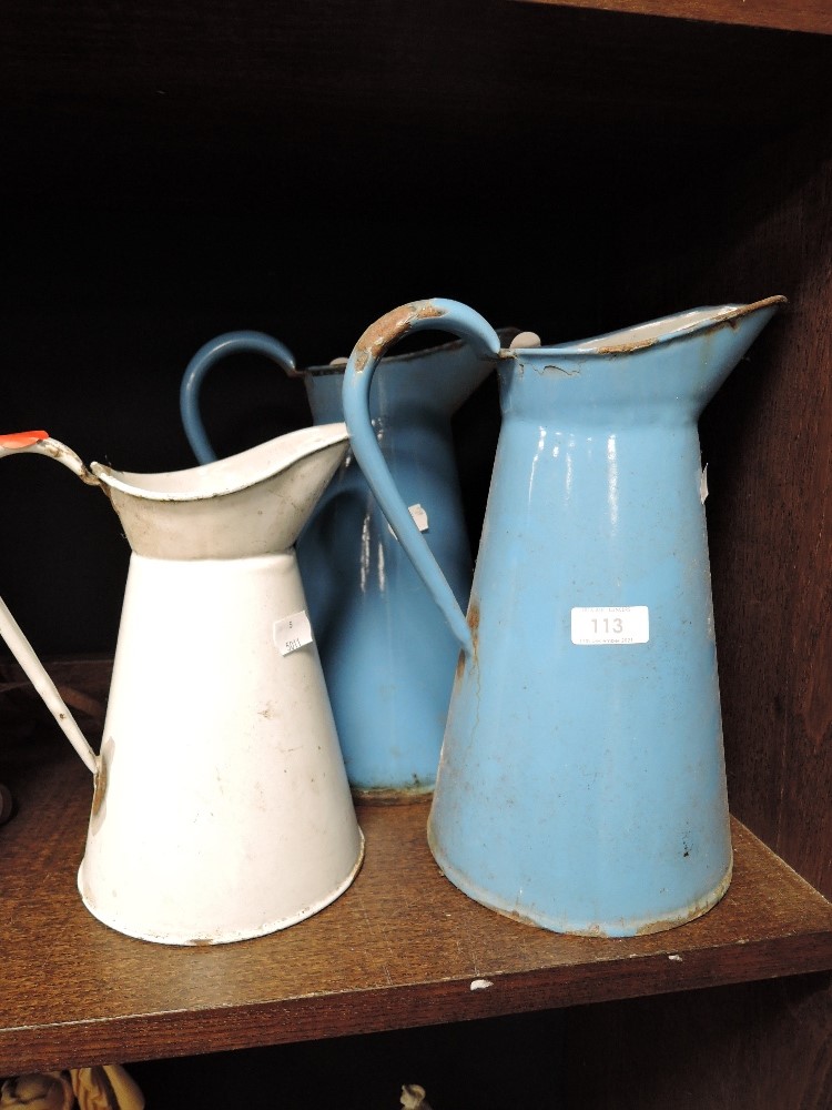 Three vintage graded enamel jugs.