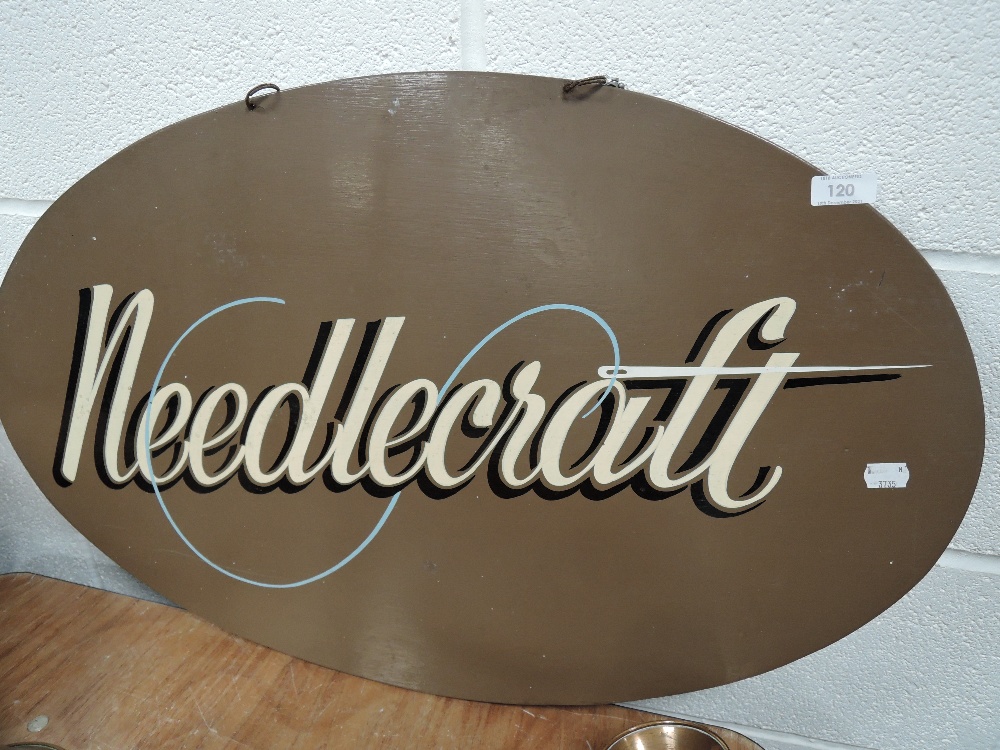 A hand painted sign for Needlecraft