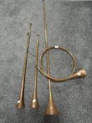 Three post or carriage copper horns and a similar hunting horn