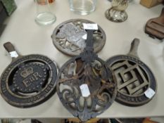 Four cast iron stove top trivets