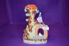 A Staffordshire flat back spill vase depicting fox, swan and young girl.