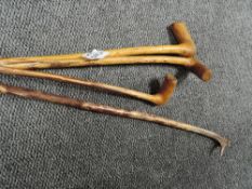 Four walking canes including antler handled example.