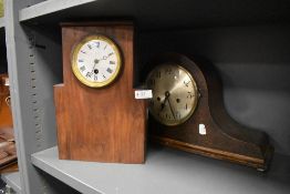 A vintage hump backed mantel clock and similar clock with Roman numerals to enamel face.