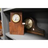 A vintage hump backed mantel clock and similar clock with Roman numerals to enamel face.