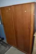 A pair of vintage golden oak 'left and right' wardrobes, possibly Gomme