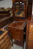 A late 19th or early 20th Century mahogany night stand having mirror back and towel rails to each