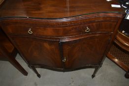 An early to mid 20th Century reproduction Regency style serpentine front side cabinet