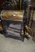 A Victorian Nautilus Grate, cast and brass fireplace, No 8172, of scrolled design, as favoured by