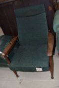 A vintage teak frame armchair upholstered in Harris Tweed