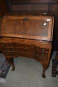 An early 20th Century walnut bureau of nice proportions having four drawer base on cabriole legs ,