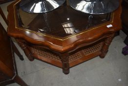 A modern stained frame octagonal coffee table having glass top and canework undertier
