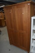 A modern golden oak wardrobe, dimensions approx W117cm H193cm D60cm, looks good quality