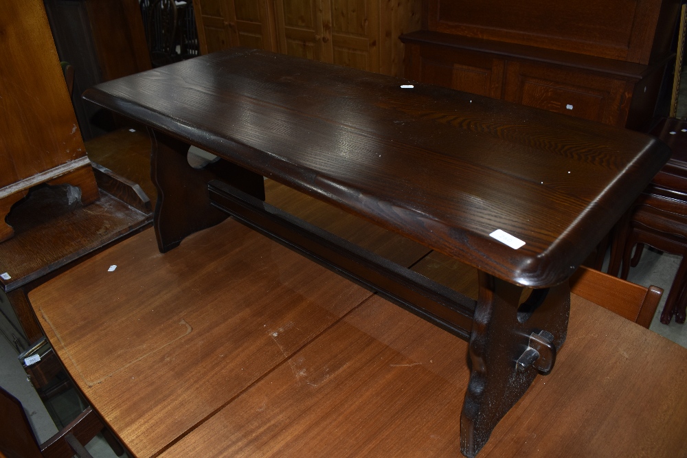 A dark stained coffee table, in the Priory style, approx. 108 x 48cm