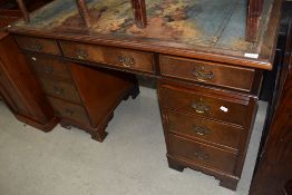 A reproduction Regency style mahogany pedestal desk, leather in need of renewing