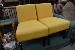 A pair of modern chairs, black and yellow