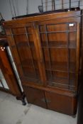 An early 20th Century mahpogany display cabinet having double cupboard to lower section, width