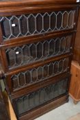 A late 19th or early 20th Century four tier oak stacking bookcase, having leaded glass fronts,