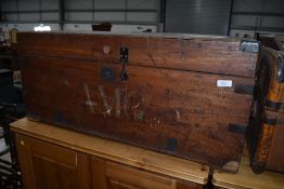 A traditional wooden bedding trunk having wrought iron handles