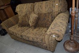 A modern settee in the traditional style, having turned legs and brass castors, looks a nice