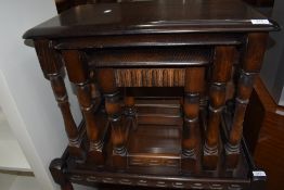 A priory style dark stained nest of three tables