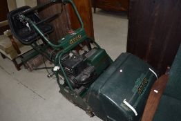 A vintage petrol ride on lawnmower by Atco having Briggs and Stratton engine