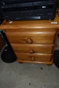 A modern pine three drawer bedside or similar chest