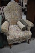 An early 20th Century wingback armchair