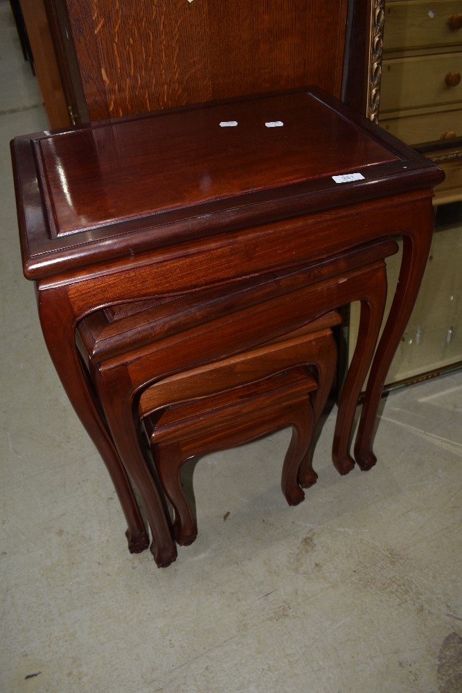 A nest of four oriental hardwood occasional tables