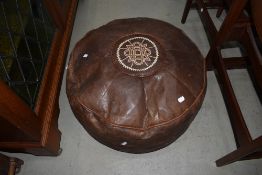 A vintage leather pouffe