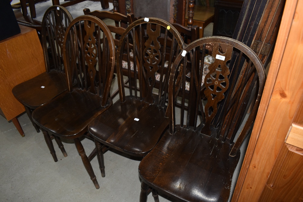A set of four traditional wheelback kitchen chairs