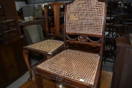 An early 20th Century mahogany frame bedroom chair having slat back, bergere canework seat and
