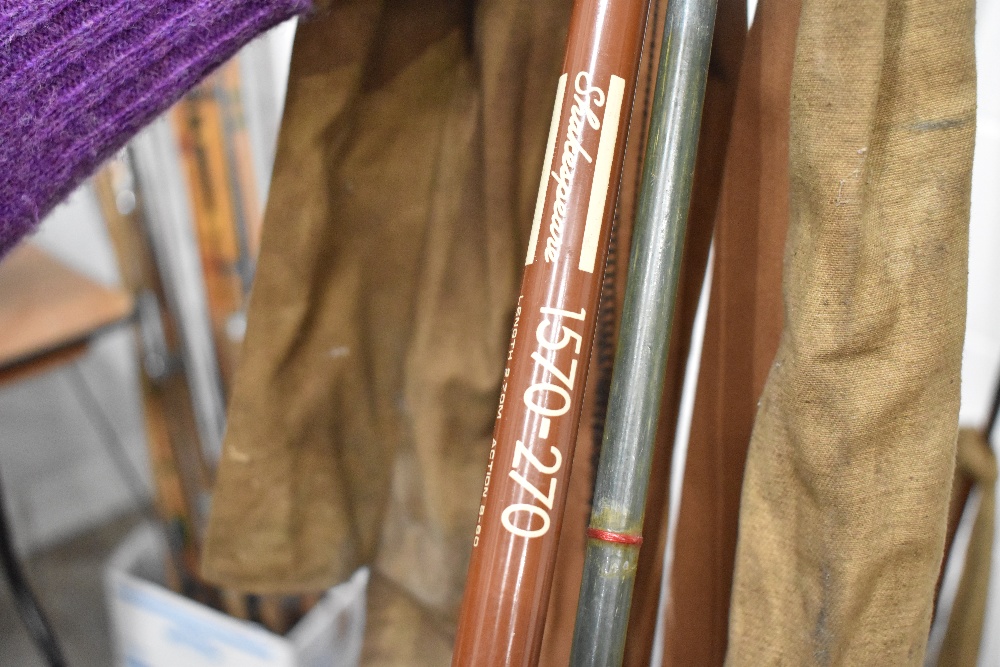 Two vintage fishing rods with sleeves.