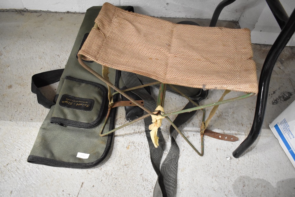 A portable stool,gun slip and canvas cartridge bag.