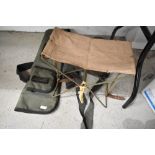 A portable stool,gun slip and canvas cartridge bag.