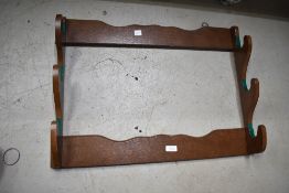 A wooden three rifle gun rack