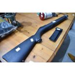 A Rugger 10/22 black synthetic stock with barrel band and folding saw knife