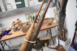 A vintage three piece split cane fly rod and Edgar Sealy live fibre fly rod in sleeves.